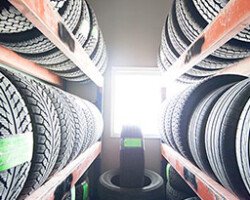 Rows of new tires stacked on warehouse racks