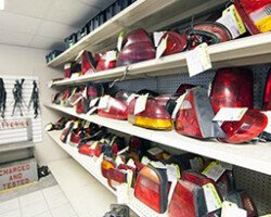 Used tail lights displayed on auto parts shelves